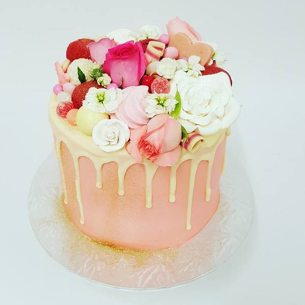Smooth Light Pink cake with White Chocolate Drip and Overload Toppings