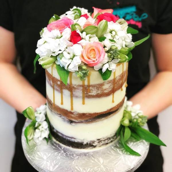 Multi Flavoured Naked Cake with Fresh Flowers and Caramel Drip.