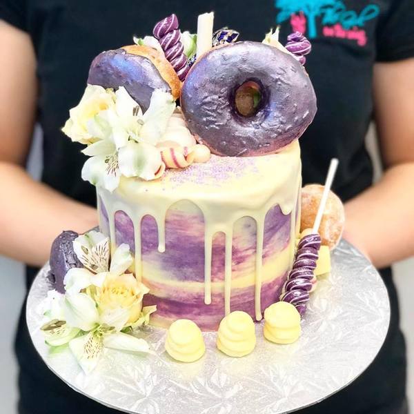 Purple Donut Overload Cake with Fresh Flowers