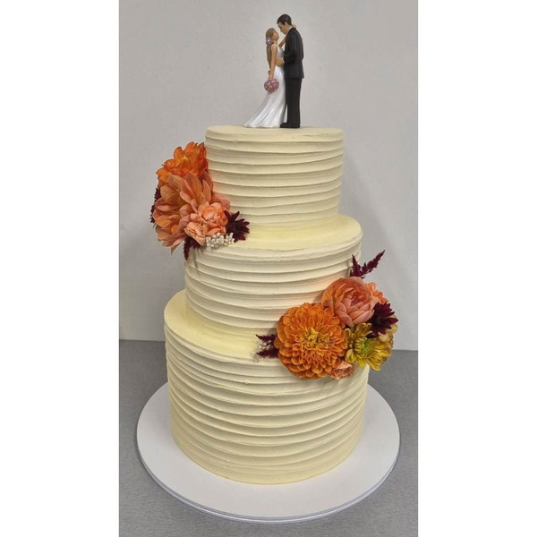 3 Tier Ribbed Wedding cake with peach and orange flowers