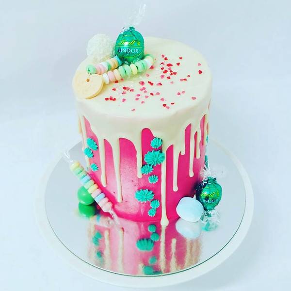 Smooth Bright Pink Cake with White Chocolate Drip and Toppings