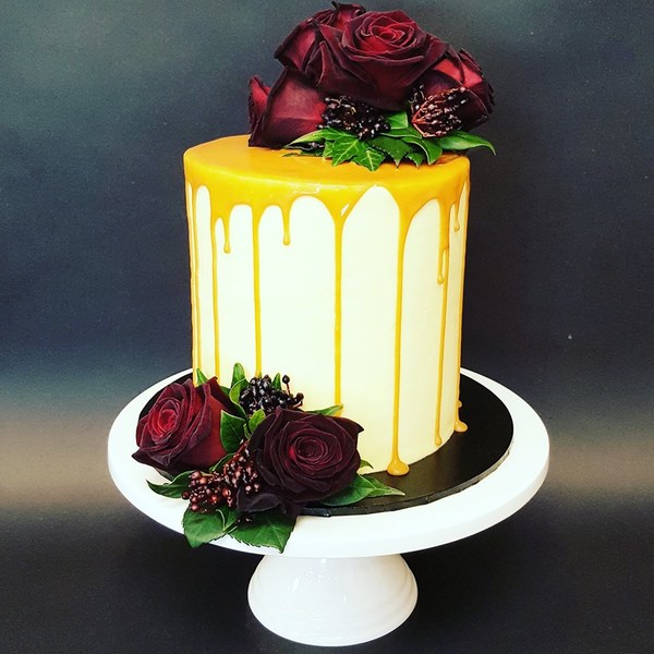 Smooth Cream Cake with Caramel Drip and Fresh Flowers