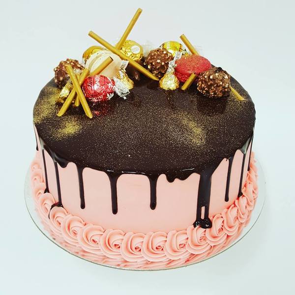 Smooth Pink Cake with Chocolate Drip and Chocolate Toppings