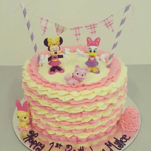 Cream and Pink Ruffle Cake with Minnie Mouse Figurines and Bunting